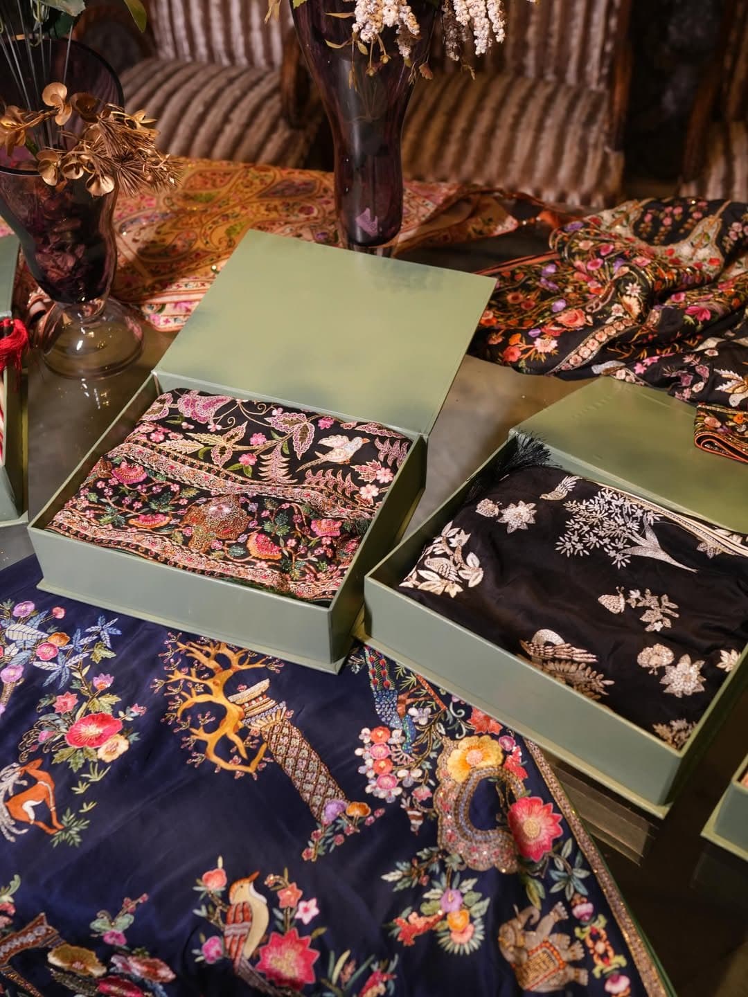 Finished shawls folded into the studio's boxes, ready to be sent out.